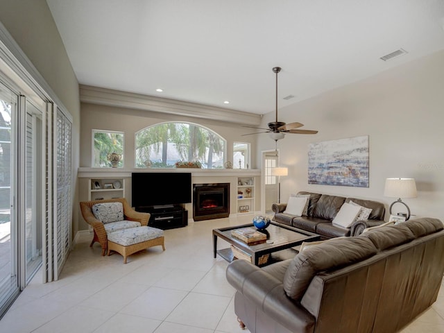 4335 Clairidge Way, Palm Harbor, FL 34685 - living room featuring light tile patterned floors, a warm lit fireplace, ceiling fan, and recessed lighting