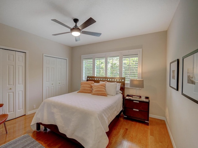 4335 Clairidge Way, Palm Harbor, FL 34685 - bedroom with two closets, wood finished floors, and ceiling fan