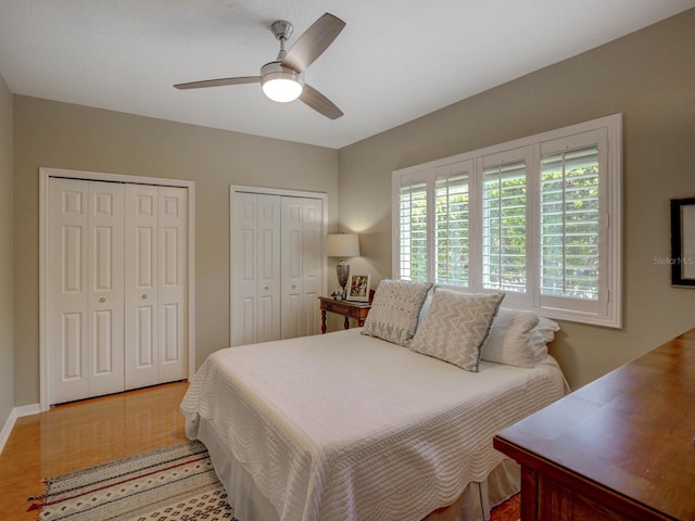 4335 Clairidge Way, Palm Harbor, FL 34685 - bedroom with wood finished floors, multiple closets, and ceiling fan