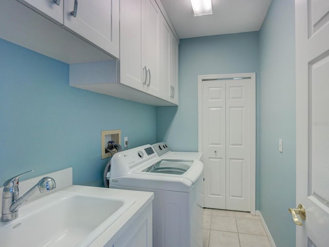 4335 Clairidge Way, Palm Harbor, FL 34685 - laundry area featuring washer and dryer, cabinet space, and light tile patterned floors