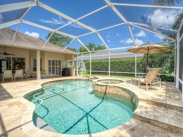 4335 Clairidge Way, Palm Harbor, FL 34685 - view of swimming pool featuring a ceiling fan, a patio area, a pool with connected hot tub, and glass enclosure