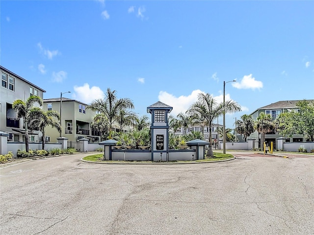 4567 Tuscan Loon Dr, Tampa, FL 33619 - view of asphalt street featuring street lights, a residential view, and curbs