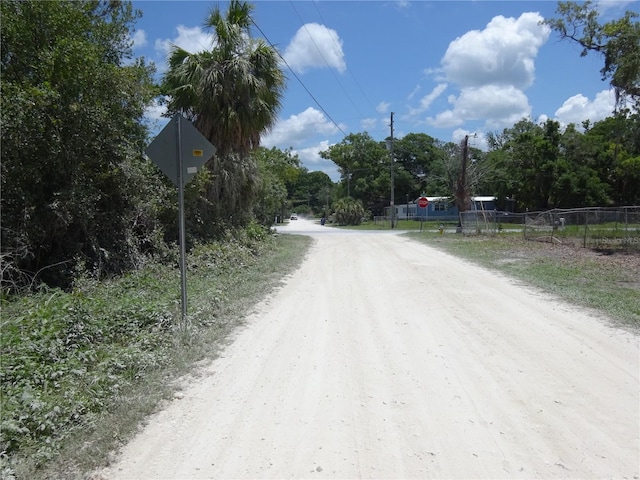 8617 Broad St, New Port Richey, FL 34654 - view of dirt / gravel road featuring traffic signs