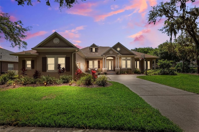 5823 Terncrest Dr, Lithia, FL 33547 - view of front of property with a yard, stucco siding, french doors, and driveway