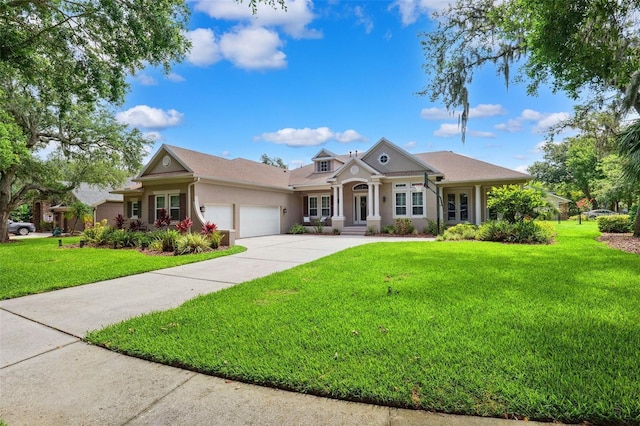 5823 Terncrest Dr, Lithia, FL 33547 - view of front facade featuring an attached garage, a front yard, concrete driveway, and stucco siding