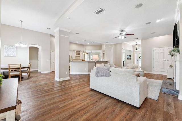 5823 Terncrest Dr, Lithia, FL 33547 - living area featuring a ceiling fan, dark wood-style flooring, recessed lighting, arched walkways, and a chandelier