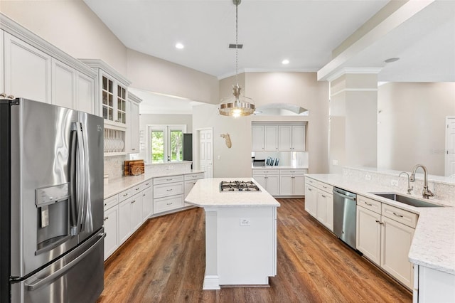 5823 Terncrest Dr, Lithia, FL 33547 - kitchen featuring appliances with stainless steel finishes, a center island, crown molding, glass insert cabinets, and recessed lighting