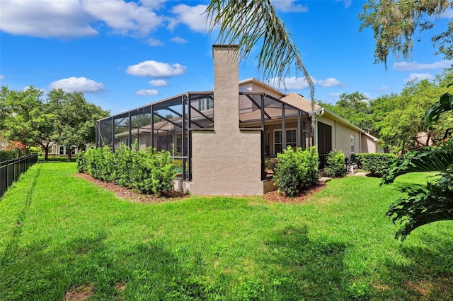 5823 Terncrest Dr, Lithia, FL 33547 - back of property with a chimney, stucco siding, and glass enclosure