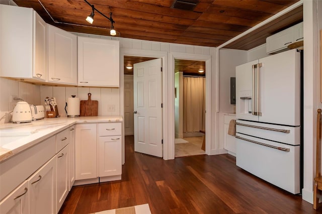 19209 Crooked Ln, Lutz, FL 33548 - kitchen with high end fridge, wood ceiling, white cabinetry, track lighting, and dark wood-style floors