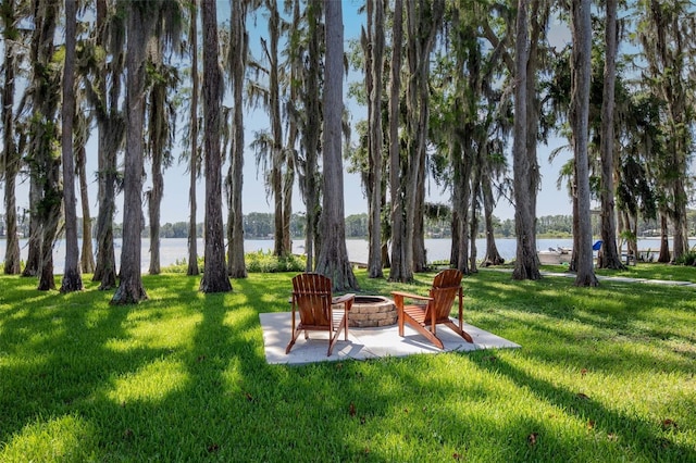 19209 Crooked Ln, Lutz, FL 33548 - view of green lawn with a fire pit, a water view, and a patio