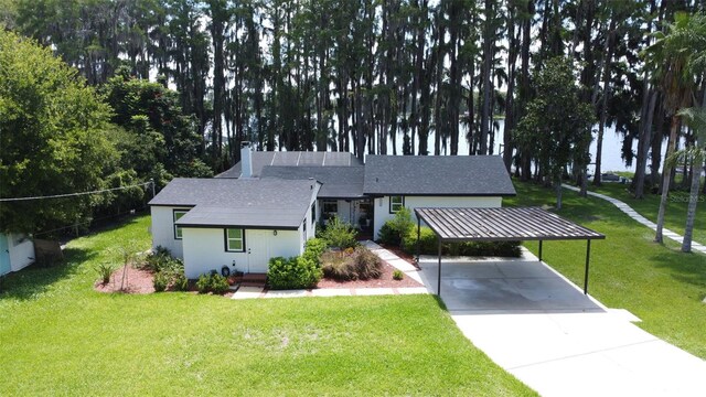 19209 Crooked Ln, Lutz, FL 33548 - view of front of property featuring concrete driveway, a front yard, a shingled roof, and a chimney