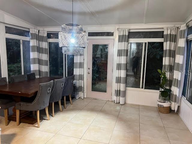 1050 Starkey Rd Unit 106, Largo, FL 33771 - dining room featuring tile patterned flooring and a chandelier