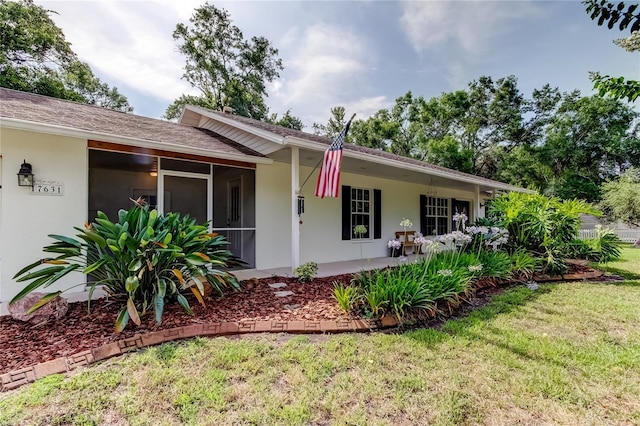 17631 Grove View Dr, Lutz, FL 33549 - single story home with stucco siding, a front yard, and a sunroom