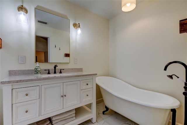 17631 Grove View Dr, Lutz, FL 33549 - bathroom with marble look tile flooring, a freestanding bath, and vanity