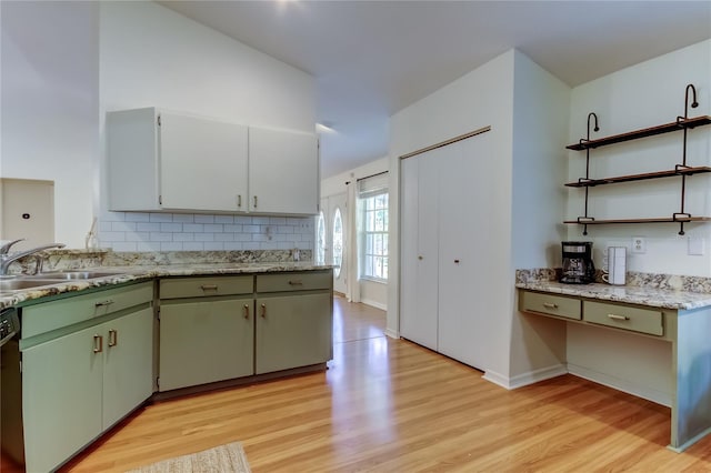 17631 Grove View Dr, Lutz, FL 33549 - kitchen featuring open shelves, light wood-type flooring, tasteful backsplash, light countertops, and dishwashing machine