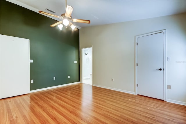 17631 Grove View Dr, Lutz, FL 33549 - unfurnished bedroom with light wood finished floors, connected bathroom, lofted ceiling, and ceiling fan