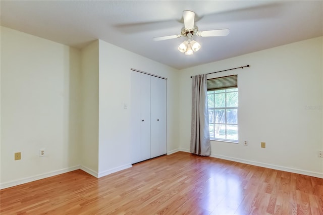 17631 Grove View Dr, Lutz, FL 33549 - unfurnished bedroom with light wood finished floors, a closet, and a ceiling fan
