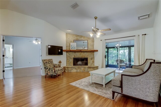 17631 Grove View Dr, Lutz, FL 33549 - living area featuring ceiling fan, vaulted ceiling, wood finished floors, and a fireplace