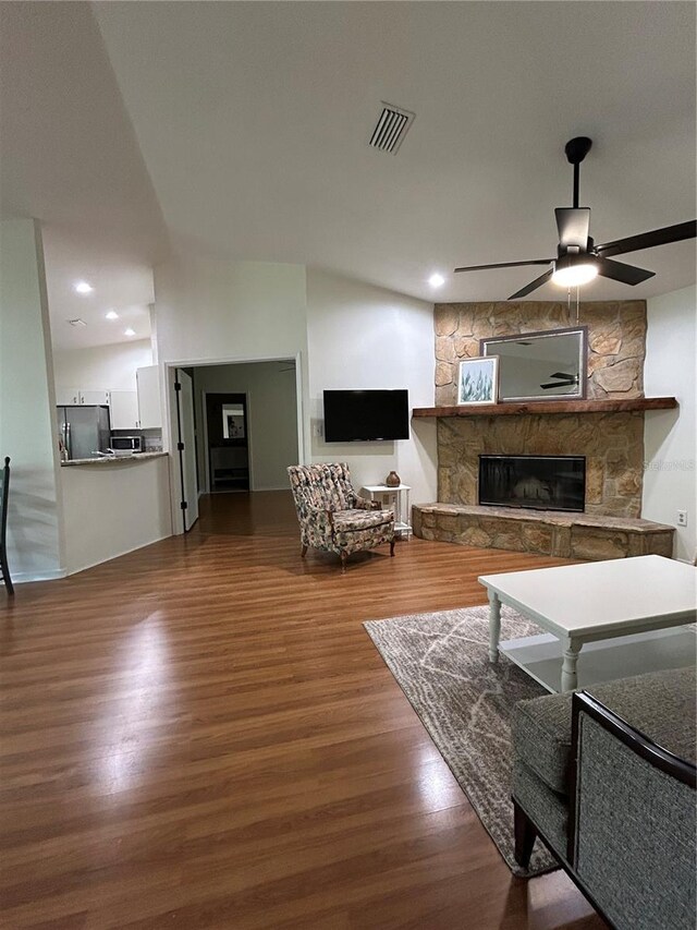 17631 Grove View Dr, Lutz, FL 33549 - living area featuring a stone fireplace, ceiling fan, and wood finished floors