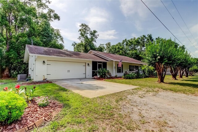17631 Grove View Dr, Lutz, FL 33549 - single story home with driveway, an attached garage, stucco siding, and a front lawn