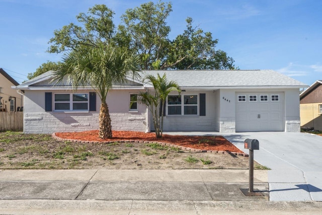 6442 Sutherland Ave, New Port Richey, FL 34653 - single story home featuring a garage, concrete driveway, stone siding, and stucco siding