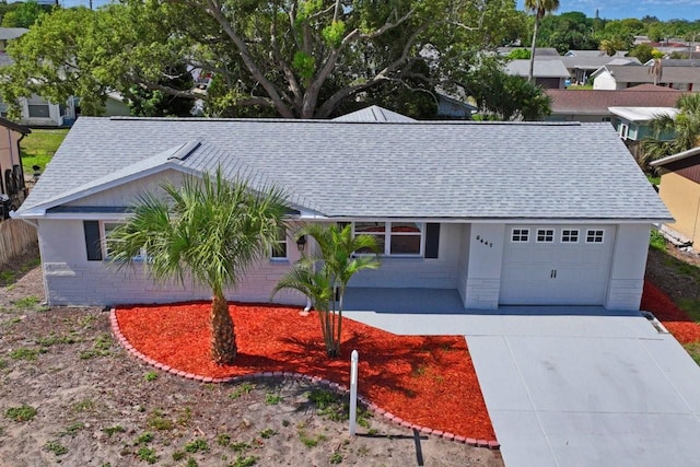 6442 Sutherland Ave, New Port Richey, FL 34653 - single story home featuring a shingled roof, an attached garage, and driveway