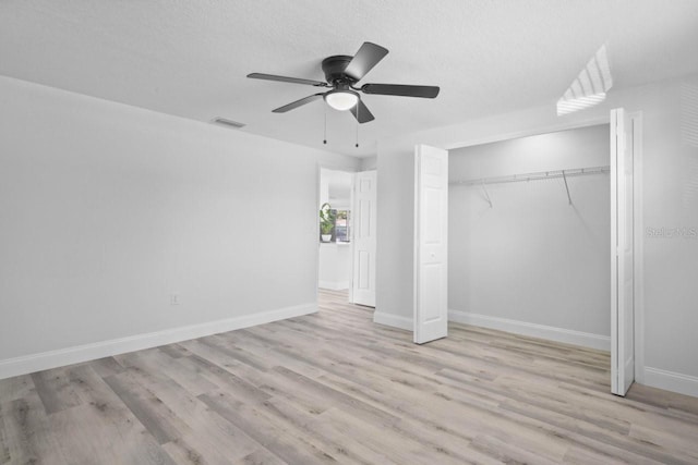 6442 Sutherland Ave, New Port Richey, FL 34653 - unfurnished bedroom with wood finished floors, a closet, a ceiling fan, and a textured ceiling