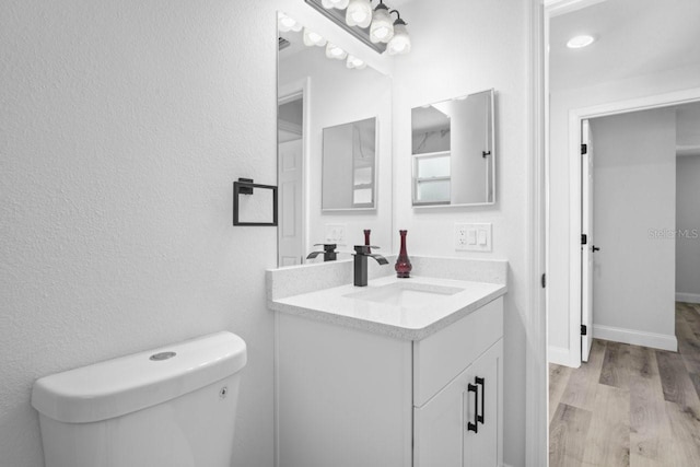 6442 Sutherland Ave, New Port Richey, FL 34653 - half bathroom featuring vanity and wood finished floors