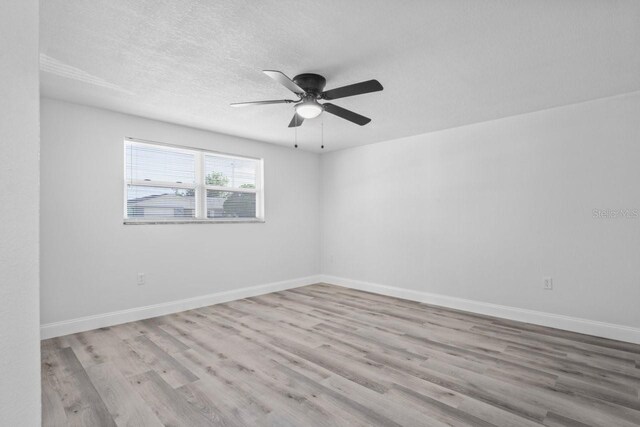 6442 Sutherland Ave, New Port Richey, FL 34653 - unfurnished room featuring wood finished floors, ceiling fan, and a textured ceiling