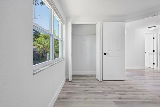 6442 Sutherland Ave, New Port Richey, FL 34653 - unfurnished bedroom featuring wood finished floors and a closet