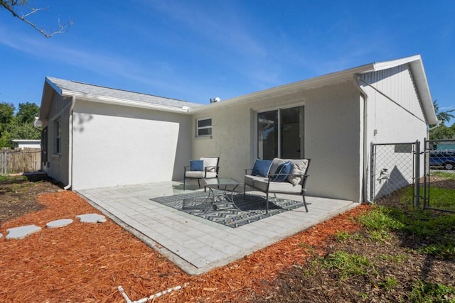 6442 Sutherland Ave, New Port Richey, FL 34653 - back of house with a patio, stucco siding, and a gate