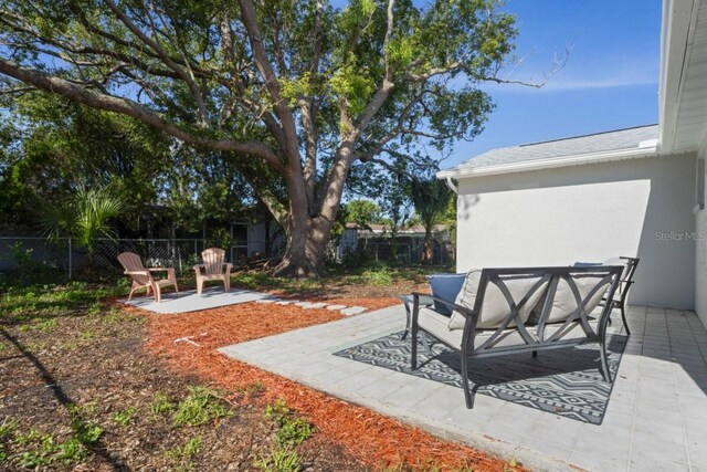 6442 Sutherland Ave, New Port Richey, FL 34653 - fenced backyard featuring a patio and outdoor lounge area