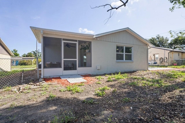 6442 Sutherland Ave, New Port Richey, FL 34653 - back of property with a sunroom and stucco siding