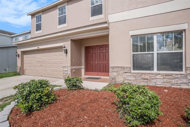 7641 Armonk Ln, Wesley Chapel, FL 33545 - entrance to property featuring stone siding, stucco siding, and a garage