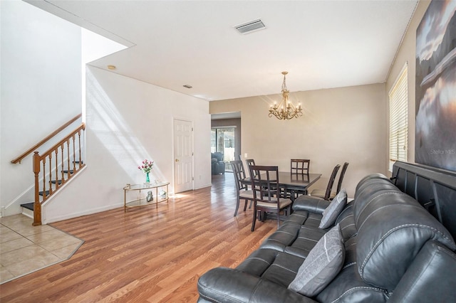 7641 Armonk Ln, Wesley Chapel, FL 33545 - living room with a chandelier, light wood-style flooring, and stairs