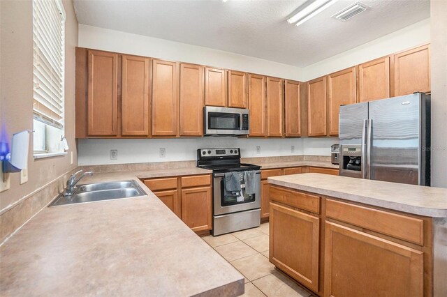 7641 Armonk Ln, Wesley Chapel, FL 33545 - kitchen with stainless steel appliances, light countertops, and light tile patterned floors