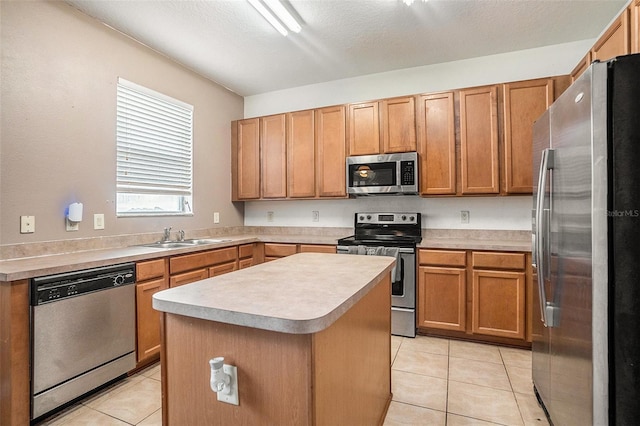 7641 Armonk Ln, Wesley Chapel, FL 33545 - kitchen featuring stainless steel appliances, light tile patterned floors, a kitchen island, light countertops, and brown cabinets