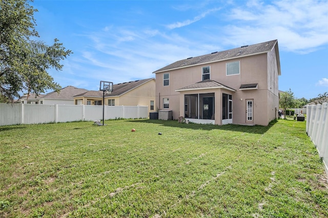 7641 Armonk Ln, Wesley Chapel, FL 33545 - rear view of property with a sunroom, stucco siding, a fenced backyard, and roof with shingles