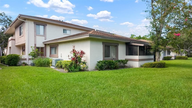 1851 Bough Ave Unit A, Clearwater, FL 33760 - view of side of home with stucco siding and a lawn