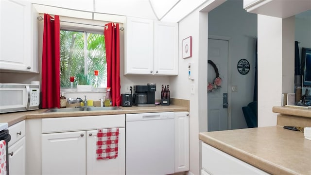 1851 Bough Ave Unit A, Clearwater, FL 33760 - kitchen featuring white appliances, white cabinets, and light countertops