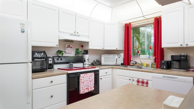 1851 Bough Ave Unit A, Clearwater, FL 33760 - kitchen with white appliances, under cabinet range hood, white cabinets, and light countertops