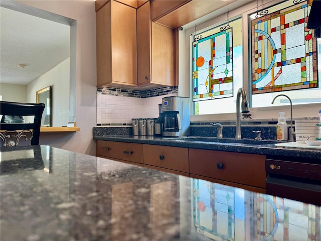 100 Bluff View Dr Unit 114C, Belleair Bluffs, FL 33770 - kitchen with brown cabinetry, dark stone counters, tasteful backsplash, and a textured ceiling