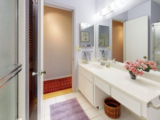100 Bluff View Dr Unit 114C, Belleair Bluffs, FL 33770 - bathroom with tile patterned floors, vanity, and a shower with shower door