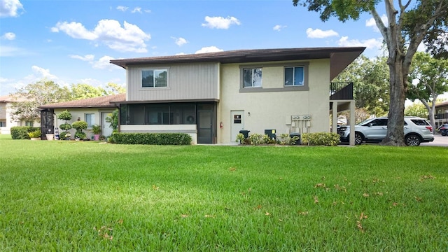 2941 Lichen Ln Unit B, Clearwater, FL 33760 - back of house featuring a lawn and stucco siding