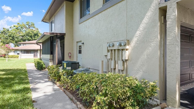 2941 Lichen Ln Unit B, Clearwater, FL 33760 - view of side of property with stucco siding and a yard