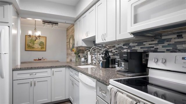 2941 Lichen Ln Unit B, Clearwater, FL 33760 - kitchen with white appliances, decorative backsplash, a chandelier, and white cabinetry