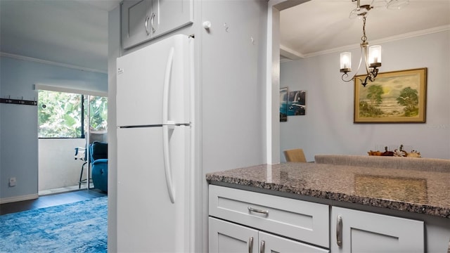 2941 Lichen Ln Unit B, Clearwater, FL 33760 - kitchen with freestanding refrigerator, crown molding, dark stone countertops, a chandelier, and hanging light fixtures