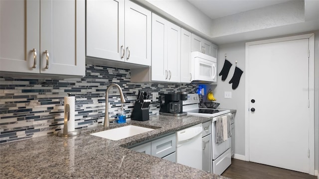 2941 Lichen Ln Unit B, Clearwater, FL 33760 - kitchen with white appliances, backsplash, light stone counters, dark wood-style floors, and white cabinetry
