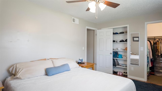 2941 Lichen Ln Unit B, Clearwater, FL 33760 - bedroom with carpet floors, a textured ceiling, a spacious closet, and ceiling fan
