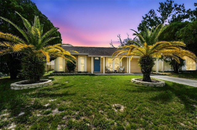 3628 Dellefield St, New Port Richey, FL 34655 - view of front of property with an attached garage, a yard, and driveway